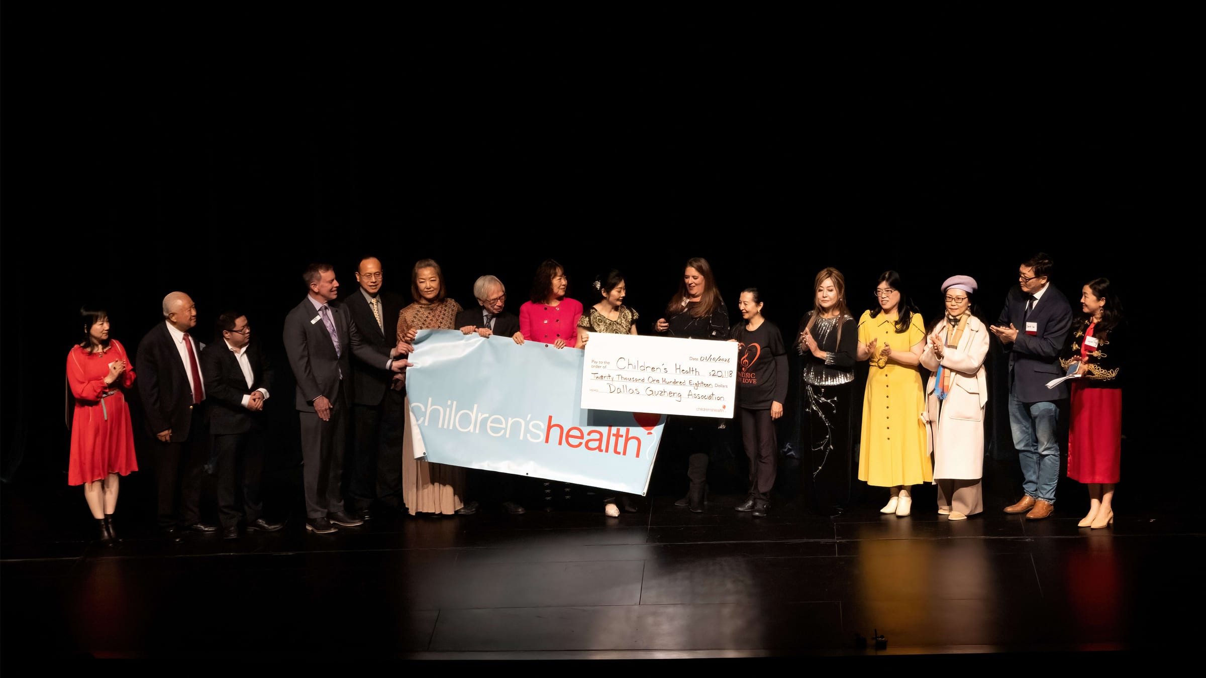 Crystal Zheng presents the $20,118 check to Children's Health